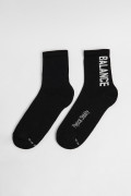 Medias largas unicolores con texturas y diseño lateral