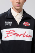 Buzo college oversize negro cuello alto con cremallera