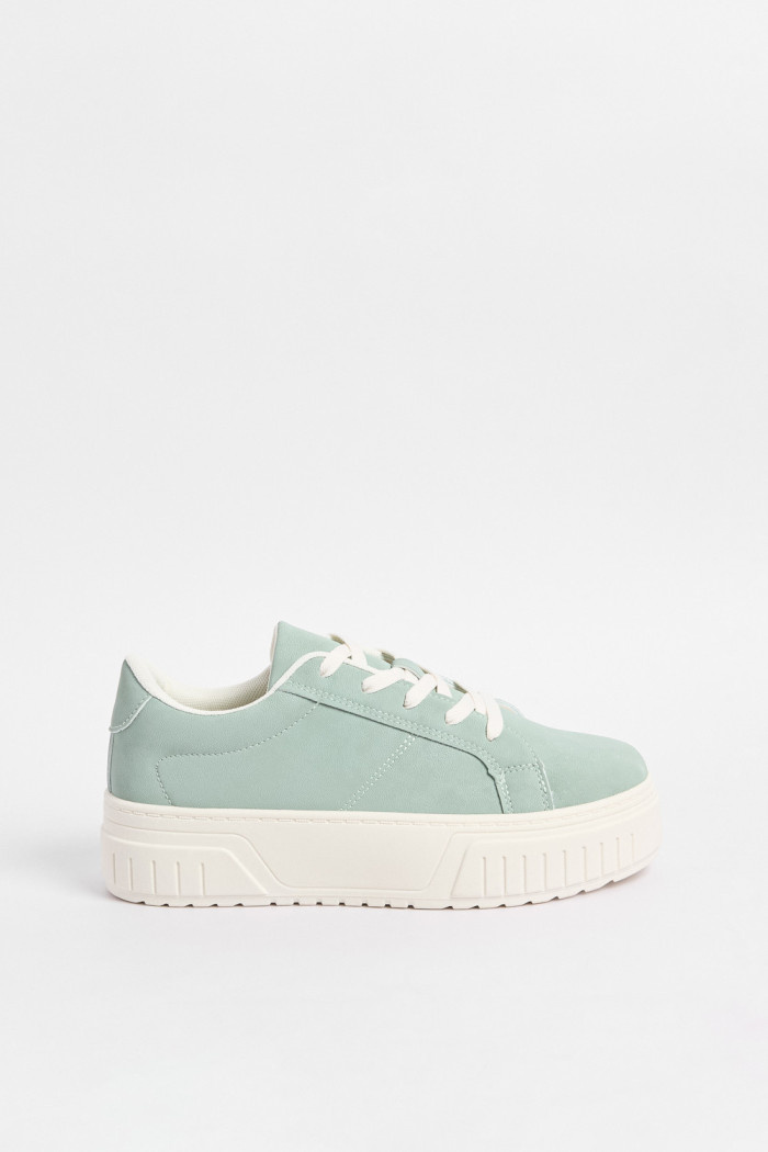 Tenis casuales verdes con suelas planas blancas
