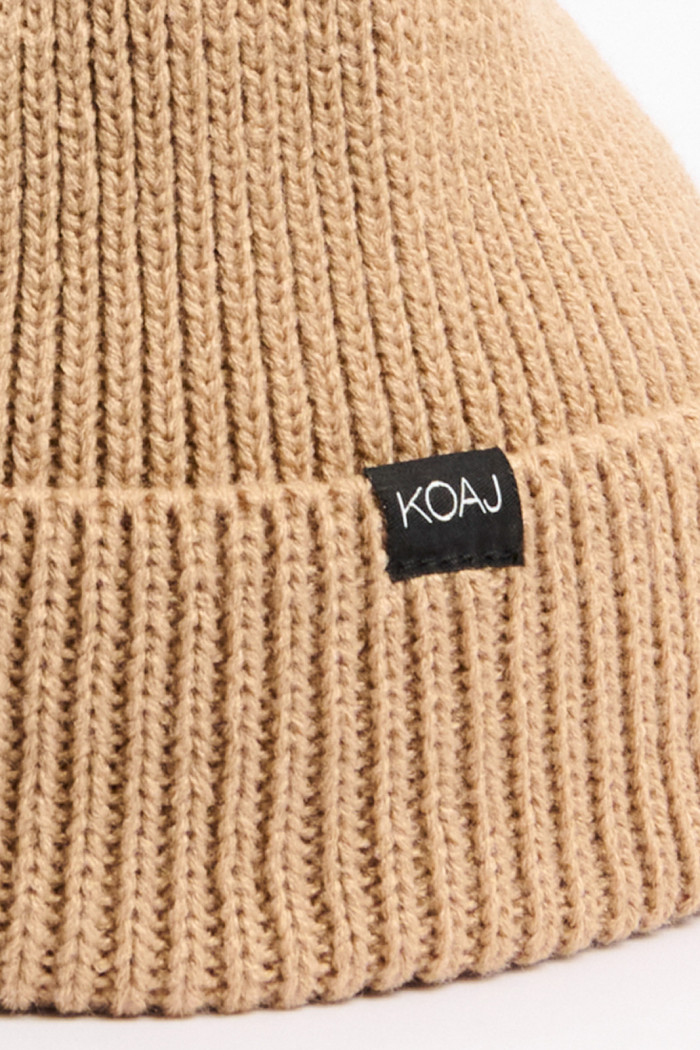 Gorro unicolor tejido con marquilla y doblez en frente
