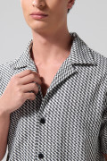 Camisa negra con diseños de figuras y cuello resort