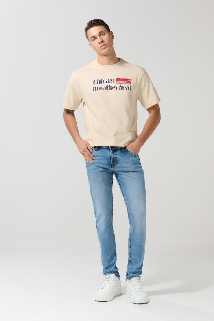 Jean tiro bajo skinny azul medio con desgastes y bolsillos