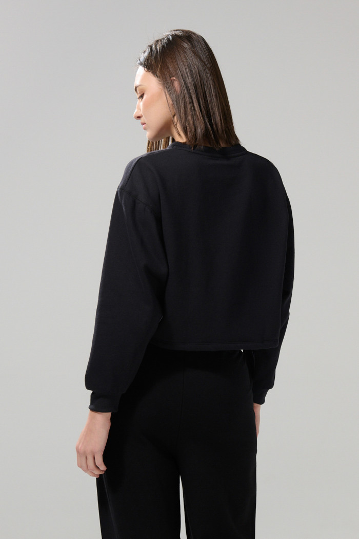 Buzo unicolor crop top cuello redondo con manga larga