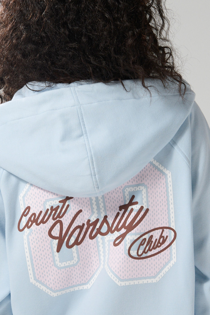 Buzo azul college oversize con cremallera y capota