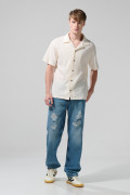 Jean 90´S tiro medio azul con bota ancha y rotos