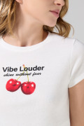 Camiseta crema con cuello redondo y diseño de cerezas