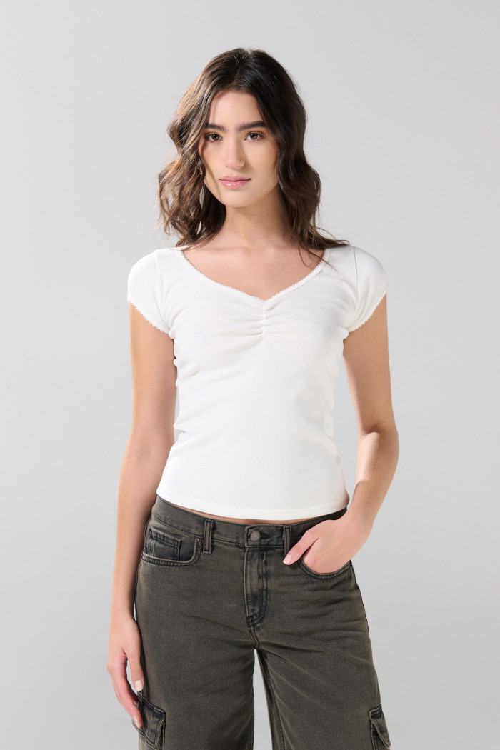 Camiseta blanca con escote en V y recogido en frente