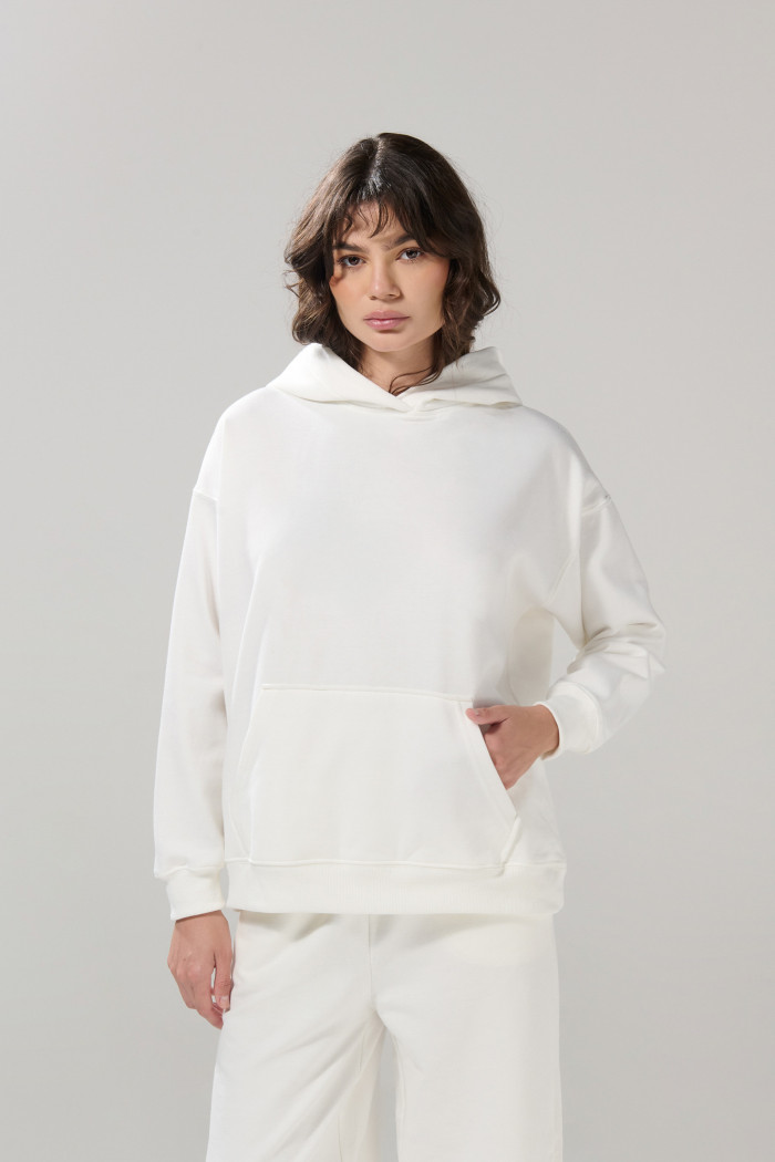 Buzo unicolor oversize perchado con bolsillo y capota