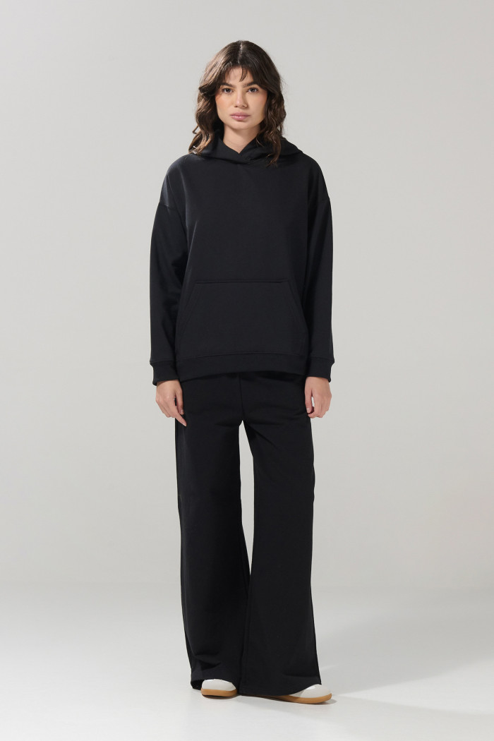 Buzo unicolor oversize perchado con bolsillo y capota