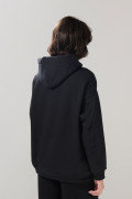 Buzo unicolor oversize perchado con bolsillo y capota