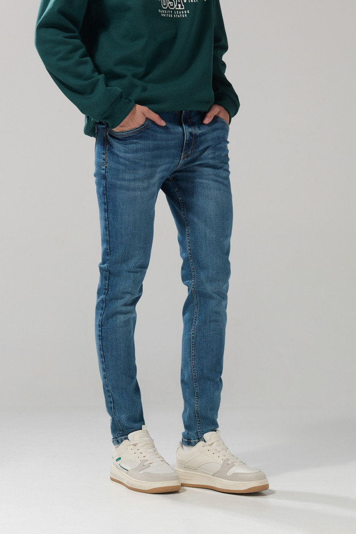 Jean skinny ajustado azul medio con tiro bajo y desgastes