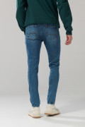 Jean skinny ajustado azul medio con tiro bajo y desgastes