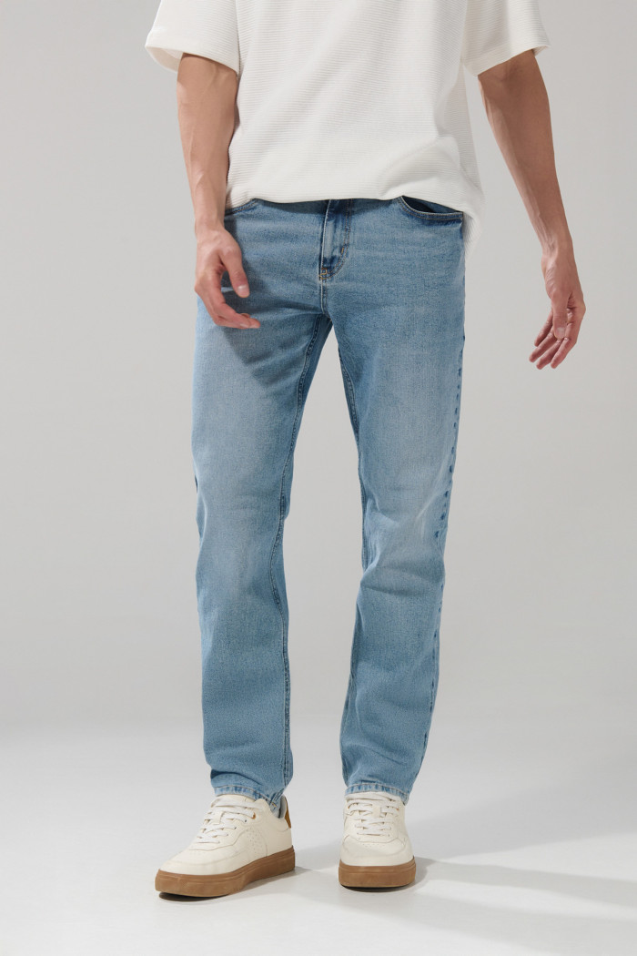 Jean azul claro slim con desgastes ligeros y tiro bajo