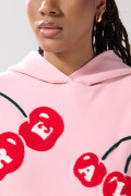 Buzo oversize rosado con capota y diseño de cerezas