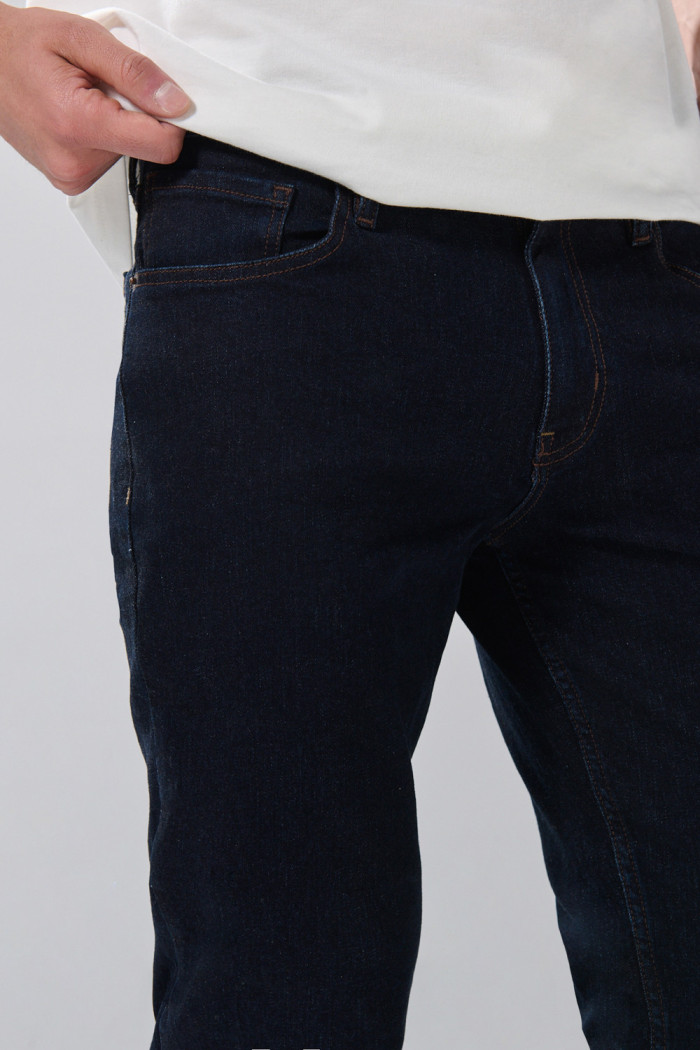 Jean azul intenso tiro bajo slim con costuras en contraste

