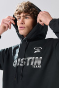 Buzo oversize negro perchado con capota y arte college