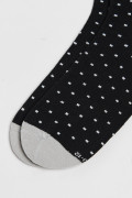 Medias largas negras con contrastes y diseños de puntos
