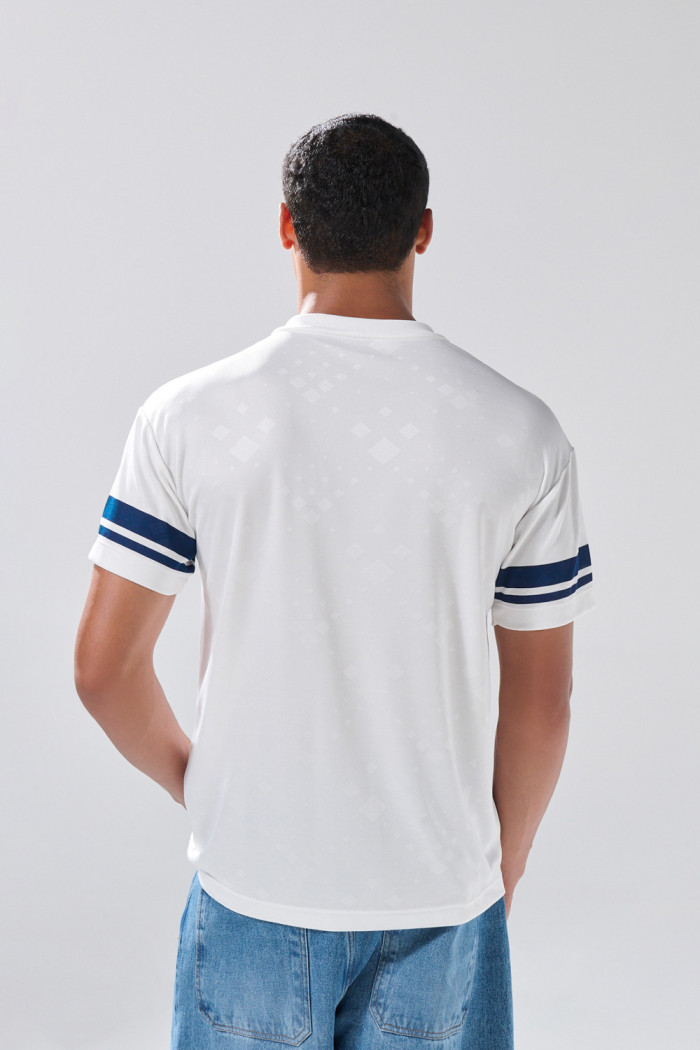 Camiseta cuello V crema clara con diseño college delantero
