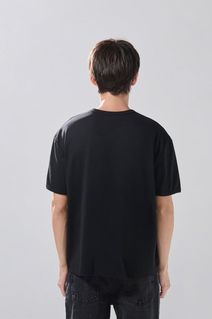 Camiseta cuello redondo unicolor con botones visibles
