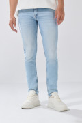 Jean skinny tiro bajo azul con desgastes y cremallera
