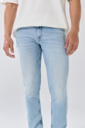 Jean skinny tiro bajo azul con desgastes y cremallera
