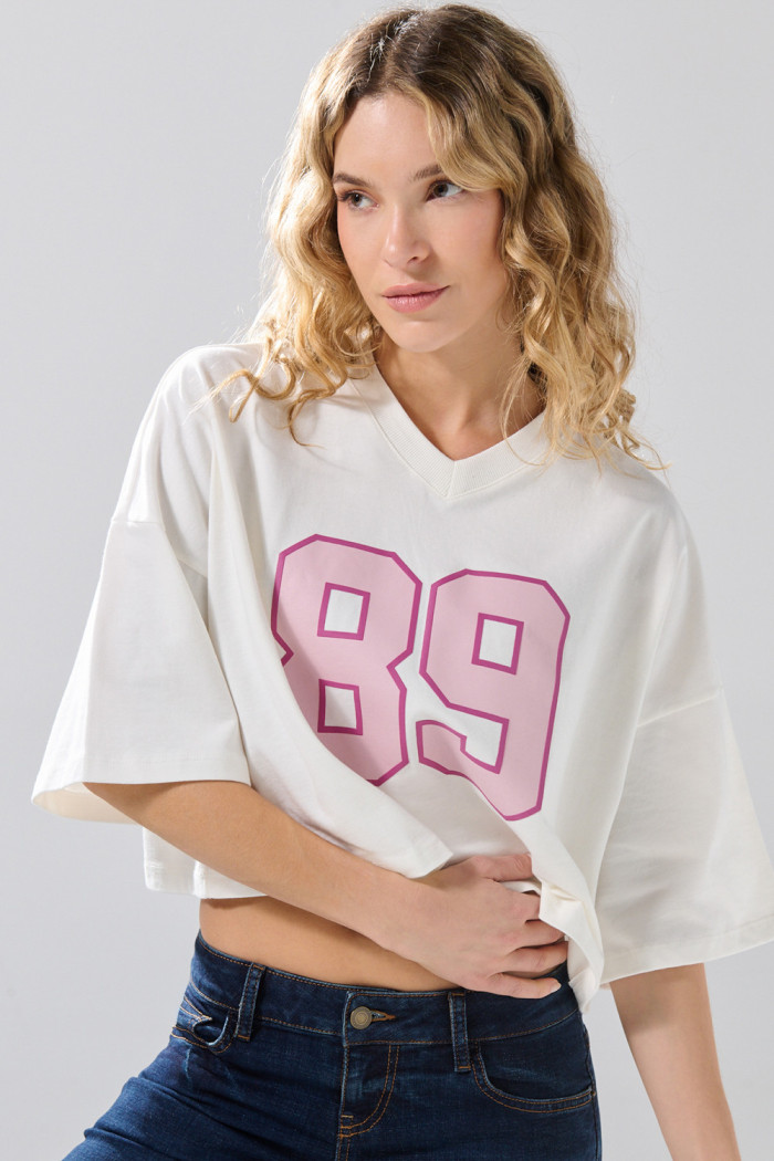 Camiseta crema oversize crop top college con cuello V
