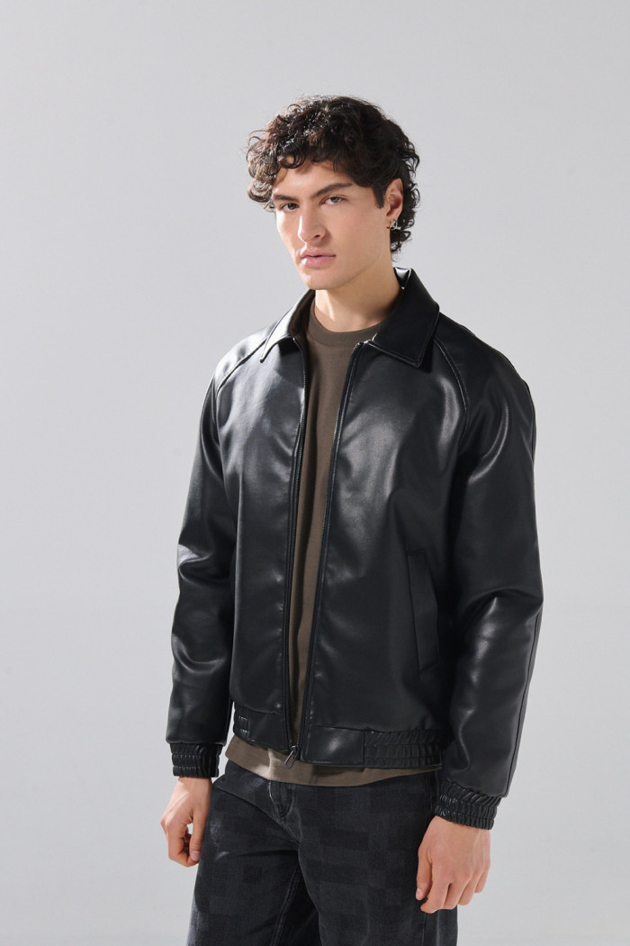 Chaqueta cuello trucker negra en PU con manga ranglan
