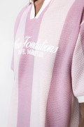 Camiseta cuello polo rosada con rayas y diseño college
