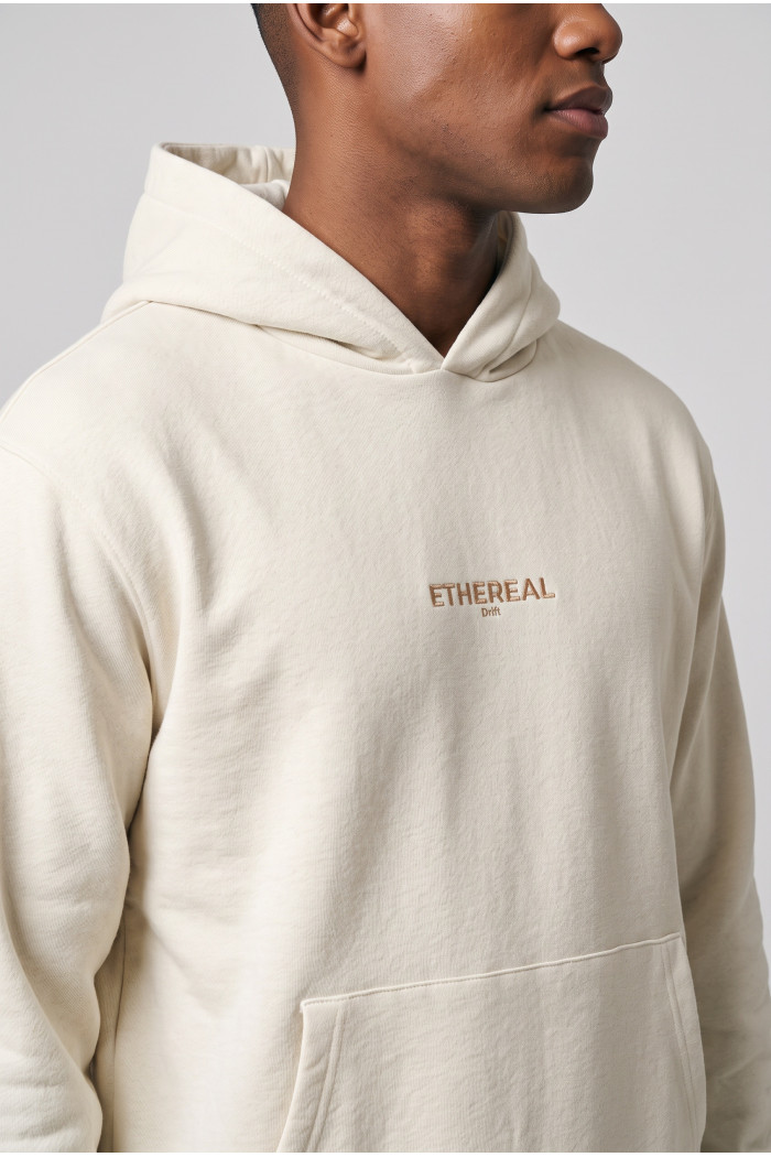 Buzo crema claro oversize con capota, bolsillo y textos
