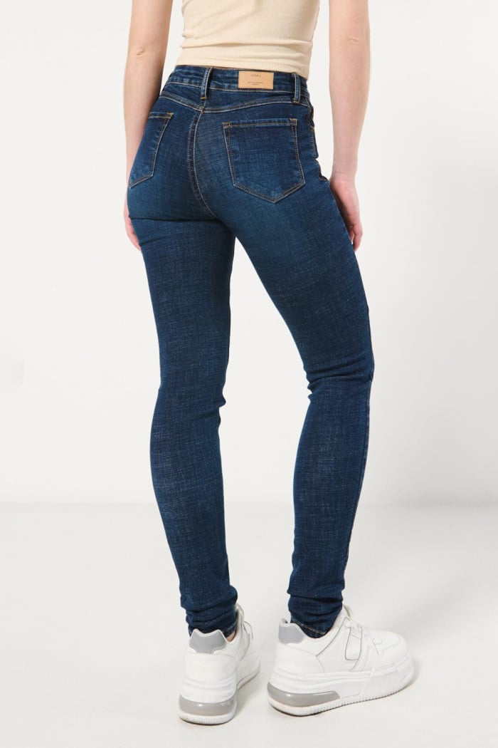 Jean súper tiro alto jegging azul oscuro con costuras cafés