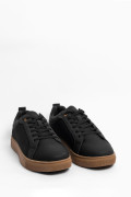 Tenis negros casuales con texturas y suelas en contraste