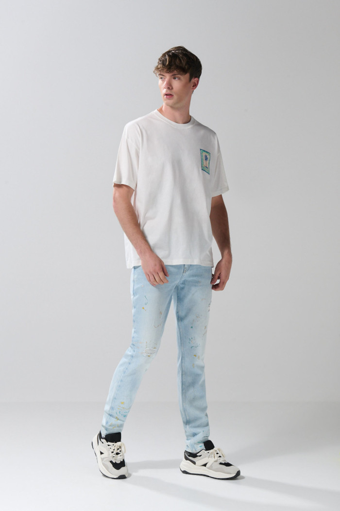 Camiseta oversize cuello redondo crema con arte de playa