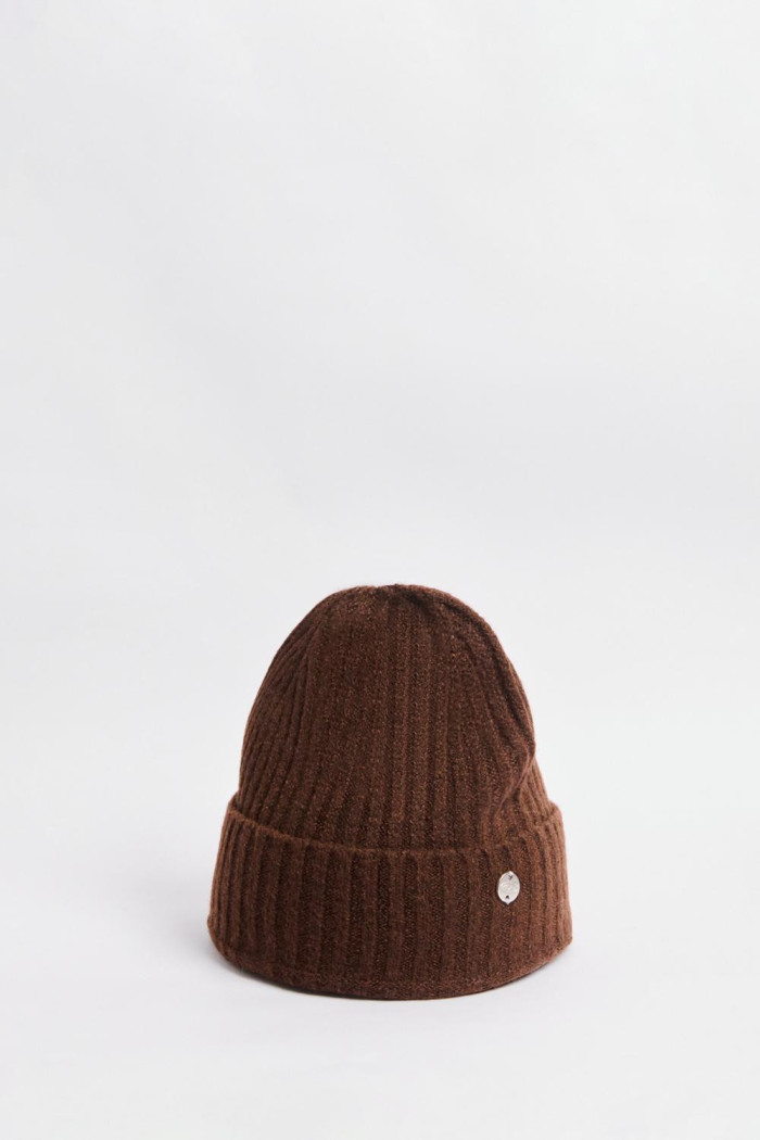 Gorro tejido unicolor con dije decorativo