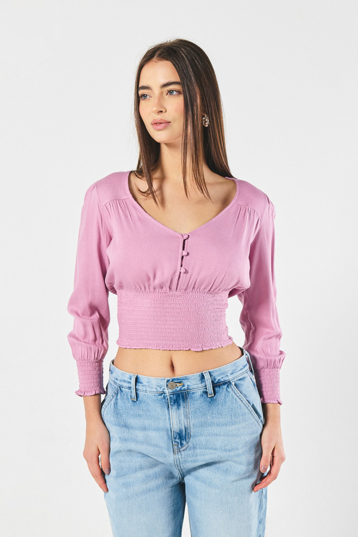 Blusa unicolor con manga larga y cintura encauchada