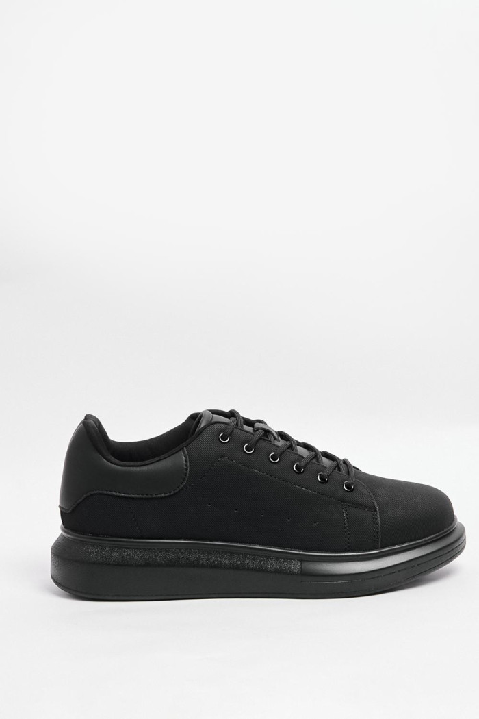 Tenis casuales negros con suelas planas elevadas