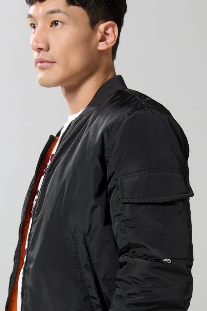 Chaqueta unicolor bomber con bolsillos y acabados en rib