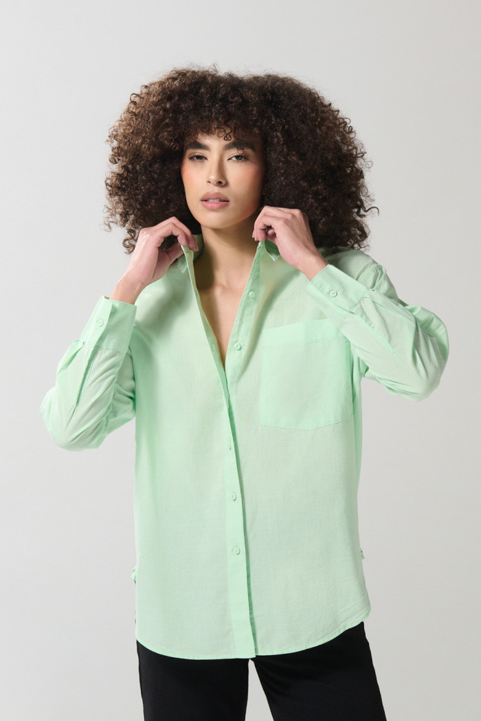 Blusa unicolor manga larga en algodón con bolsillo