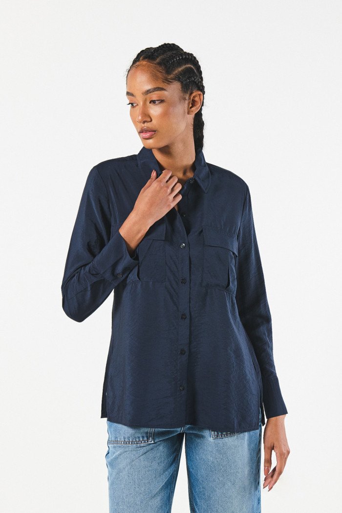 Blusa manga larga unicolor con doble bolsillo en frente