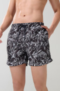 Bermuda negra playera con diseños de hojas blancas
