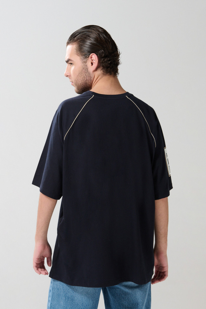 Camiseta azul oversize con arte college y manga ranglan