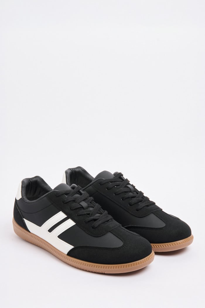 Tenis negros casuales con contrastes blancos y suelas planas