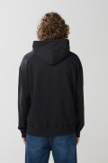 Buzo oversize negro con capota y diseño de Superman