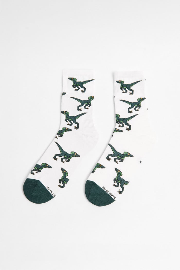 Medias cremas largas con diseños de dinosaurios