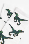 Medias cremas largas con diseños de dinosaurios