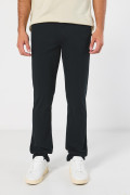 Pantalón unicolor en dril con ajuste ceñido y tiro medio