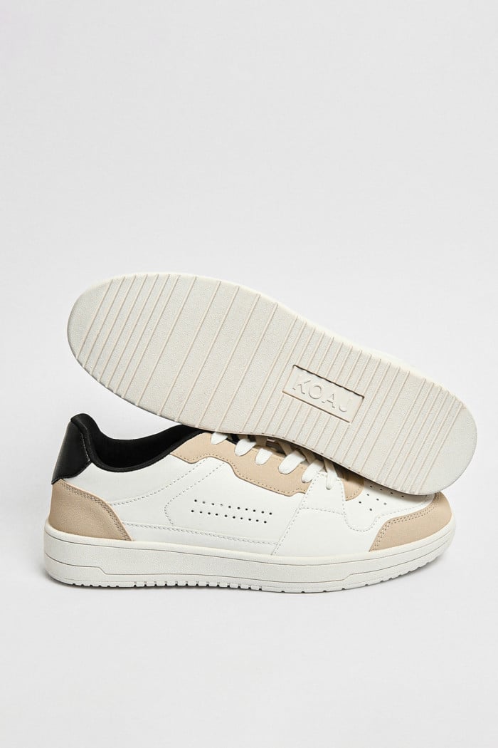 Tenis planos unicolores con perforaciones y contrastes