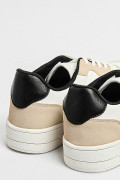 Tenis planos unicolores con perforaciones y contrastes