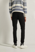 Jean súper skinny ajustado negro con cremallera y tiro bajo