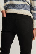 Jean súper skinny ajustado negro con cremallera y tiro bajo