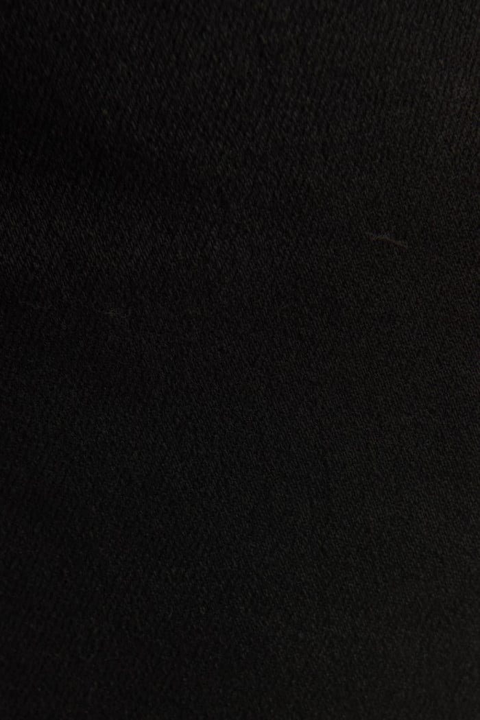 Jean súper skinny ajustado negro con cremallera y tiro bajo